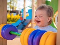 Young girl in a playground laughing 