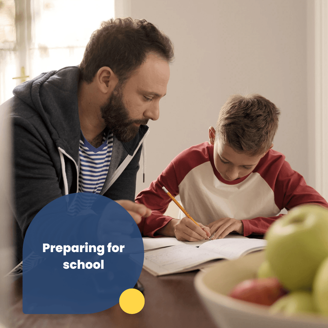 Boys is doing homework and his dad is watching. Tet says Preparing for school. 