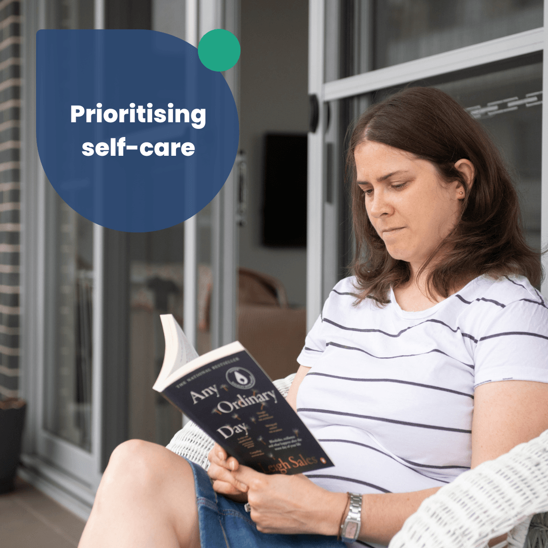 A lady has medium brown hair and a white shirt. She is reading a book. The text says prioiritising self care.