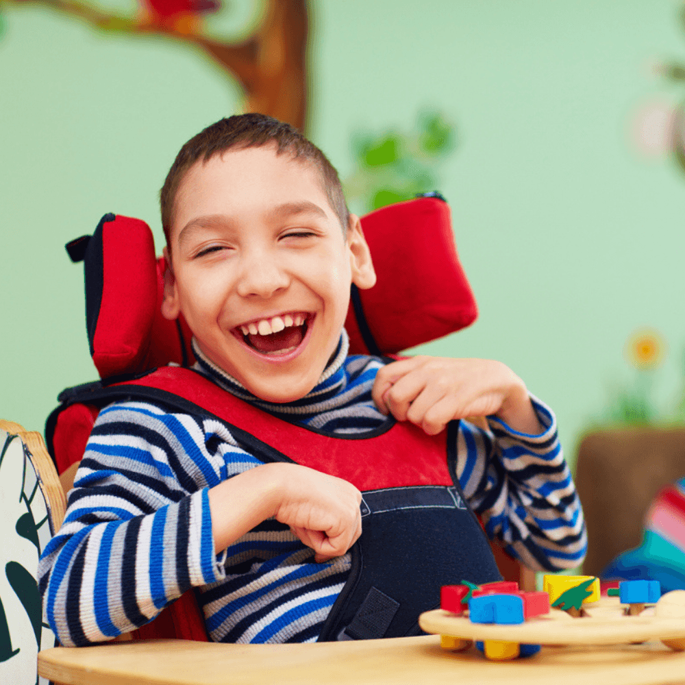 Boy sitting in chair and smiling