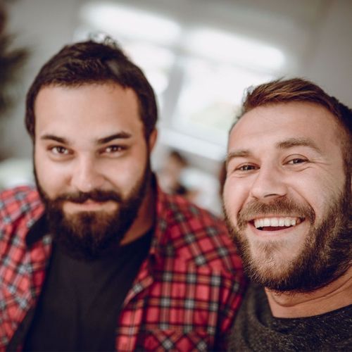 Two men smiling